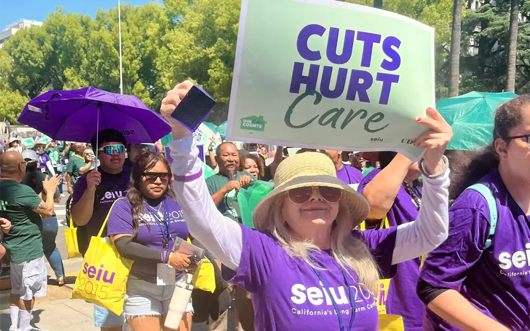 a protester with In-Home Supportive Services marching with their Union, to the steps of the Sacramento capital to protest.